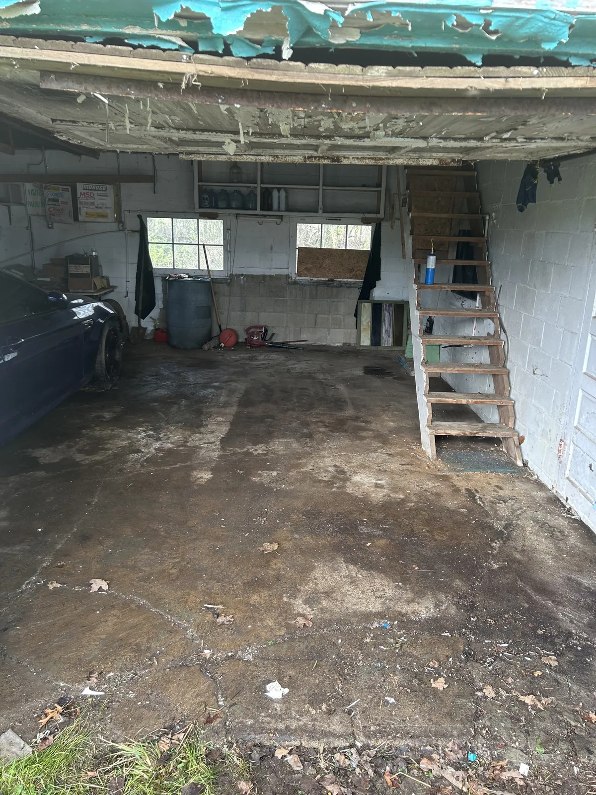 The same cinder block garage emptied to bare concrete